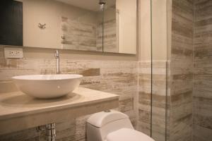 a bathroom with a sink and a toilet at The Clock Hostel & Suites in Cartagena de Indias