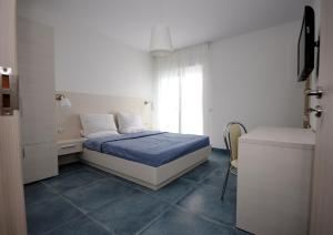 a small bedroom with a bed and a window at Apartments Harmony in Utjeha