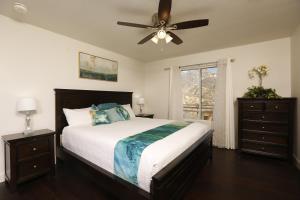 a bedroom with a bed and a ceiling fan at Shady Knoll in Three Rivers
