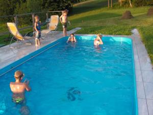 a group of children playing in a swimming pool at Krkonosska Chalupa in Semily