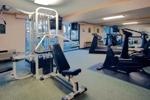 a gym with treadmills and elliptical machines at Wyndham Visalia in Visalia