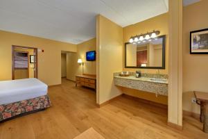 a hotel room with two beds and a television at Bearskin Lodge on the River in Gatlinburg