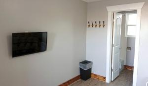 a living room with a flat screen tv on a wall at Caribou Gem in Bancroft