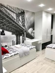 a bedroom with a bed with a painting of a bridge at Luxury Apartment - 3 lakes in Katowice