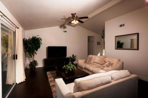 a living room with a couch and a ceiling fan at Shady Knoll in Three Rivers