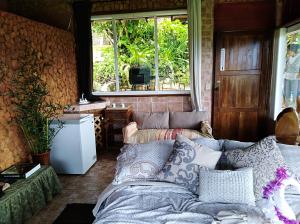 a living room with a couch and a window at Mandalas Ecolodge Ecotourismo Altos Cerro Azul, Rain Forest Natural,Chagres National Park in Cerro Azul