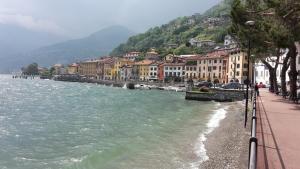 a town next to a body of water with buildings at House of cats in Domaso