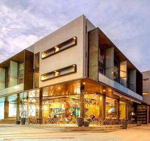 a large building with tables and chairs in front of it at Dúplex 2 las Marías in San Salvador de Jujuy