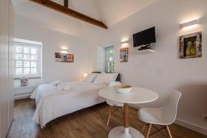 リスボンにあるSoul House - Exclusive Apartmentのベッドルーム(白いベッド1台、小さなテーブル付)