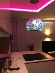 a kitchen with a counter with a pink lighting at Premium Apartment Yumbo WIFI A/C in Playa del Ingles