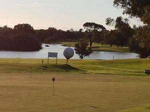 a golf course with a ball and a golf ball at (Pets Welcome) Southern Comfort in Bunbury