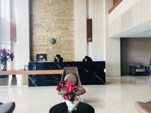 a lobby with a desk with flowers in a chair at Wind Suites Tagaytay at SMDC in Tagaytay +56 photos