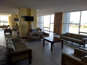 a waiting room with couches and a table in a building at Playa Club Argentina in Miramar