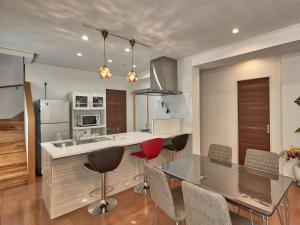 a kitchen with a glass table and chairs and a counter at The Pool Resort Villa Hasta Manana in Onna +31 photos