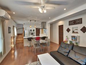 a living room with a couch and a table at The Pool Resort Villa Hasta Manana in Onna