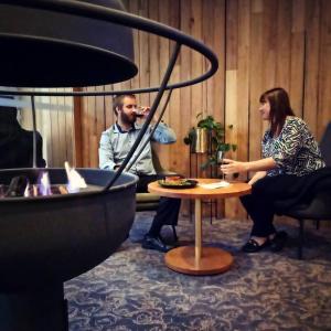 two people sitting around a table in a room at Morphett Arms Hotel in Adelaide
