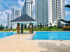 a swimming pool with a gazebo in a city at Wind Suites Tagaytay at SMDC in Tagaytay