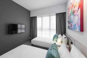 Ένα ή περισσότερα κρεβάτια σε δωμάτιο στο The Canvas Hotel