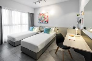 Ένα ή περισσότερα κρεβάτια σε δωμάτιο στο The Canvas Hotel