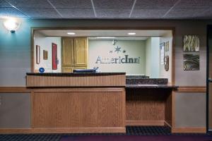 a view of the front desk of a americanith hospital at AmericInn by Wyndham Grundy Center in Grundy Center