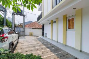 a car parked on a wooden walkway outside a house at G357 Near Margo City in Depok