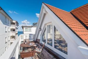 a balcony with a table and chairs and the ocean at Hotel Villa Belvedere in Binz +63 photos