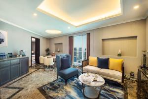 a living room with a couch and a table at Gulf Court Hotel Business Bay in Dubai