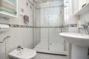 a bathroom with a shower and a sink and a toilet at Comfort Inn Old Town in Budva +14 photos