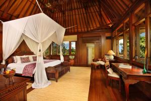 a bedroom with a bed with a mosquito net at Ibah in Ubud +106 photos