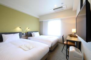 Giường trong phòng chung tại ICI HOTEL Ueno Shin Okachimachi