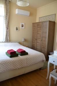 a bedroom with a bed with two pillows on it at Our House In The Town in Veliko Tŭrnovo