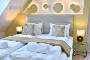a bedroom with two beds with white sheets and pillows at Hillside Premium Apartments in Budapest