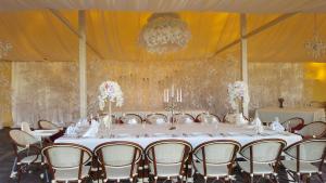 a table set up for a wedding in a tent at Sventes Muiža in Svente