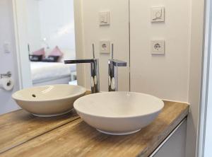 a bathroom with a white bowl sink on a counter at Charmingsuite in Bad Teinach-Zavelstein