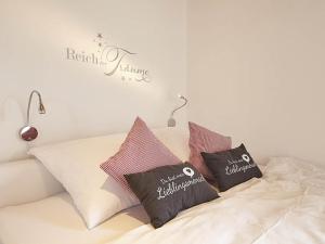 a bed with three pillows on top of it at Charmingsuite in Bad Teinach-Zavelstein