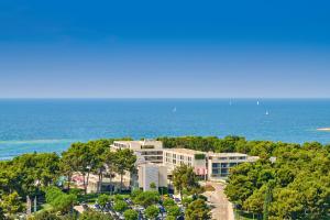 an aerial view of a building near the ocean at Hotel Parentium Plava Laguna in Poreč