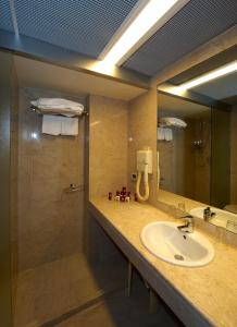 a bathroom with a sink and a mirror at Splendid Hotel La Torre in Mondello