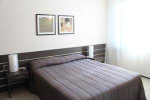 Postel nebo postele na pokoji v ubytování Hotel Residence Aurora