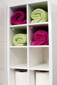 a white closet with pink and green towels at Split Mari Apartment in Split