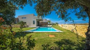 a house with a swimming pool in a yard at Iskios Villas in Agia Marina Nea Kydonias