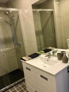 a bathroom with a sink and a shower at Destiny Oporto in Maia