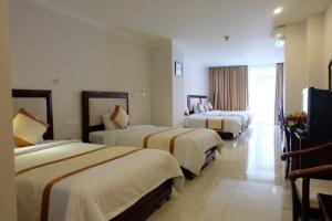 Ένα ή περισσότερα κρεβάτια σε δωμάτιο στο Indochine Hotel