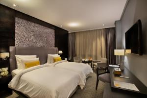a hotel room with a large bed and a desk at ODYSSEE Boutique Hotel Casablanca in Casablanca