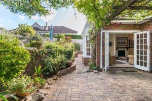 a brick house with a pathway leading to the front door at E Stamford Road in Cape Town