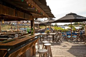 a bar with people sitting at tables and umbrellas at Hotel de Zon - Brasserie Bresson by Flow in Ommen