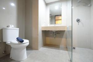 a bathroom with a toilet and a sink at Best Price Modern Studio Apartment H Residence near MT Haryono By Travelio in Jakarta +8 photos