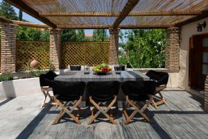 a dining table and chairs on a patio at Villa of the old olive oil factory in Ágios Konstantínos +33 photos