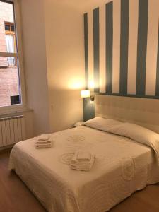 a hotel room with a bed and a table at B&B Sallustio Rooms in Siena