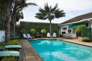a swimming pool in the backyard of a house at Carslogie House in Port Elizabeth