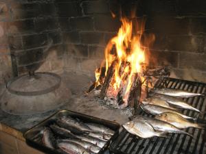 a bunch of fish cooking in a brick oven at Villa Castello in Korčula